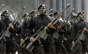 Mexican Special Forces march with .50 caliber sniper rifles; units like these have been engaged for many years in fighting their own citizens, cartel and vigilante alike. (Wikimedia Commons)