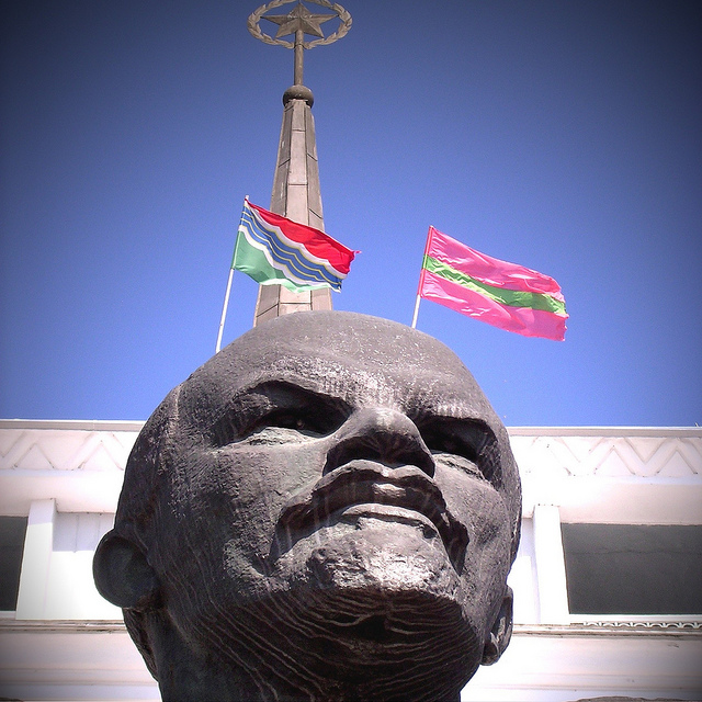 A statue of Lenin with two flags, one being the flag of Transnistria in Moldova. Photo Credit: TetterooMedia