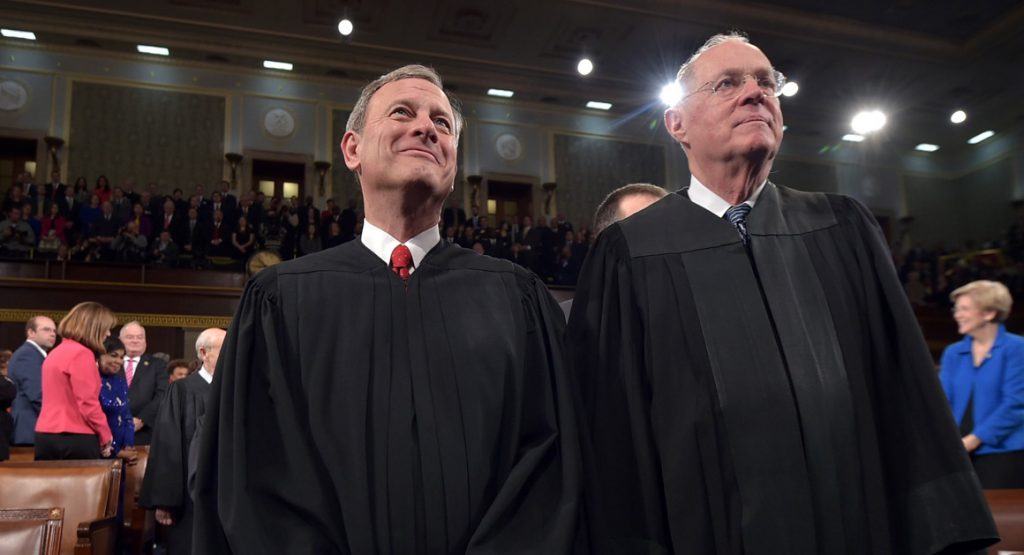 Chief Justice  John G. Roberts and Supreme Court Justice Anthony M. Kennedy stand before President Barack Obama's State Of The Union address on Tuesday, Jan. 20, 2015, on Capitol Hill in Washington. (AP Photo/Mandel Ngan, Pool)